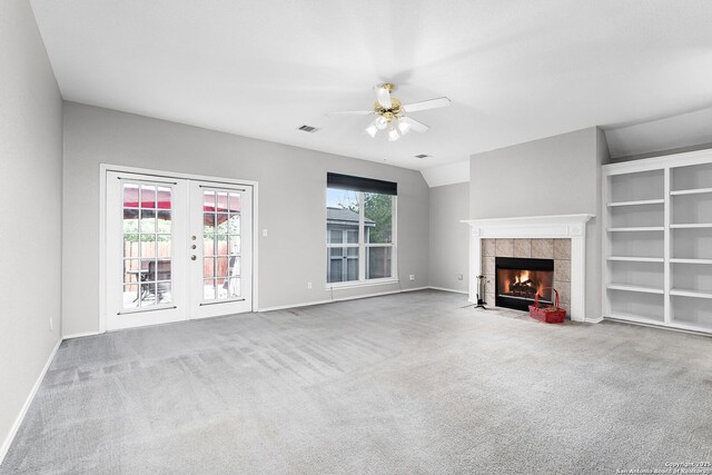 4481 Owl Crk, Schertz, TX 78154 - unfurnished living room featuring a ceiling fan, a fireplace, carpet floors, and french doors