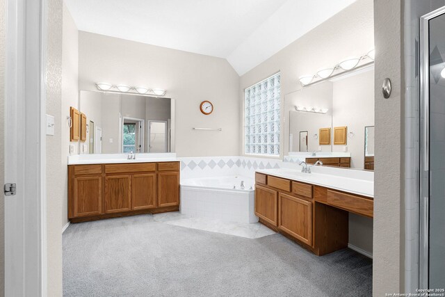 4481 Owl Crk, Schertz, TX 78154 - bathroom with vaulted ceiling, two vanities, a bath, and a shower with door