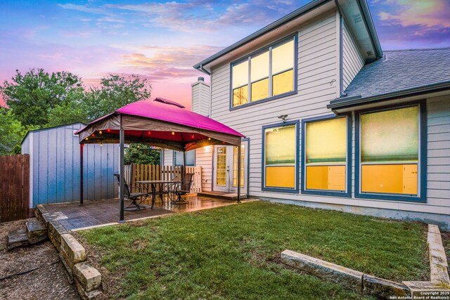 4481 Owl Crk, Schertz, TX 78154 - back of property at dusk with a gazebo, a patio area, roof with shingles, and an outdoor structure