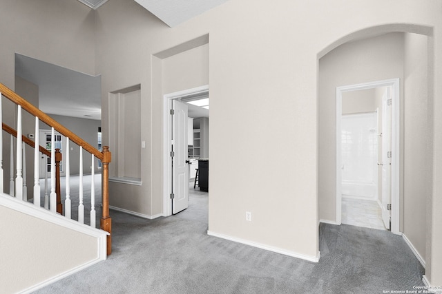 4481 Owl Crk, Schertz, TX 78154 - corridor with carpet flooring, arched walkways, and stairway
