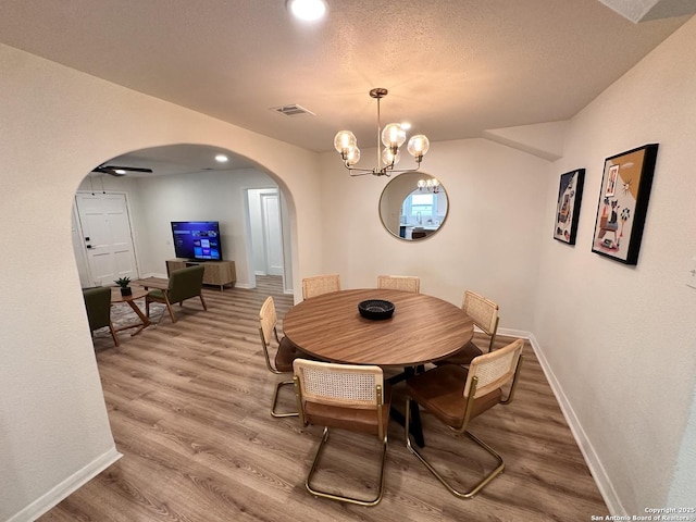 414 Clower, San Antonio, TX 78212 - dining room with arched walkways, light wood finished floors, and a chandelier