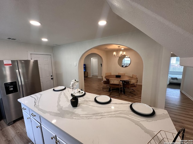 414 Clower, San Antonio, TX 78212 - kitchen featuring dark wood-style floors, arched walkways, stainless steel refrigerator with ice dispenser, recessed lighting, and a chandelier
