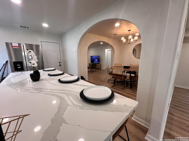 414 Clower, San Antonio, TX 78212 - dining space featuring arched walkways, wood finished floors, recessed lighting, and a chandelier