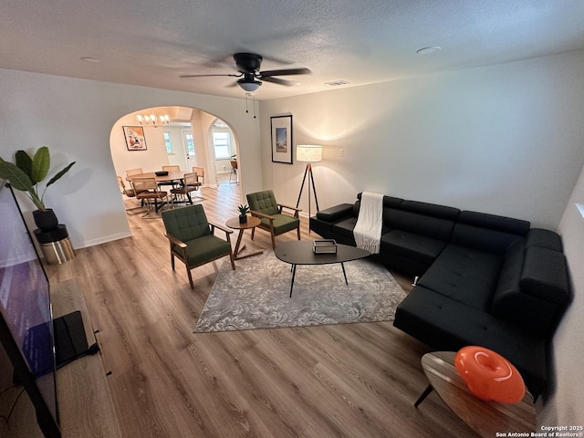 414 Clower, San Antonio, TX 78212 - living area featuring arched walkways, wood finished floors, ceiling fan, and a textured ceiling
