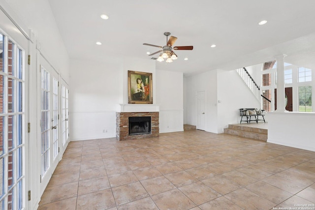 23613 Grayling Ln, San Antonio, TX 78259 - unfurnished living room with a ceiling fan, recessed lighting, french doors, a stone fireplace, and light tile patterned floors