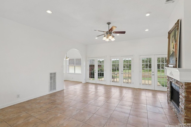 23613 Grayling Ln, San Antonio, TX 78259 - unfurnished living room featuring a ceiling fan, recessed lighting, a fireplace, light tile patterned floors, and arched walkways
