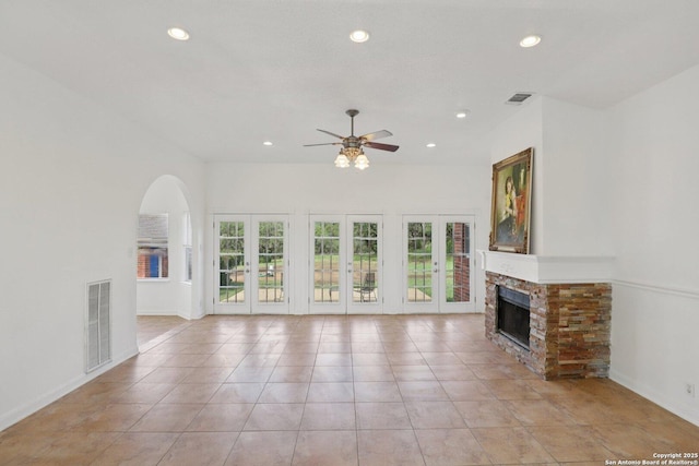 23613 Grayling Ln, San Antonio, TX 78259 - unfurnished living room featuring ceiling fan, healthy amount of natural light, a fireplace, recessed lighting, and arched walkways