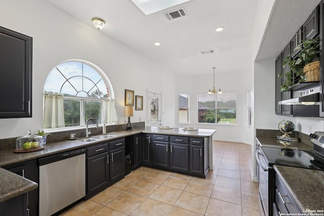 23613 Grayling Ln, San Antonio, TX 78259 - kitchen featuring appliances with stainless steel finishes, healthy amount of natural light, a chandelier, light tile patterned flooring, and recessed lighting