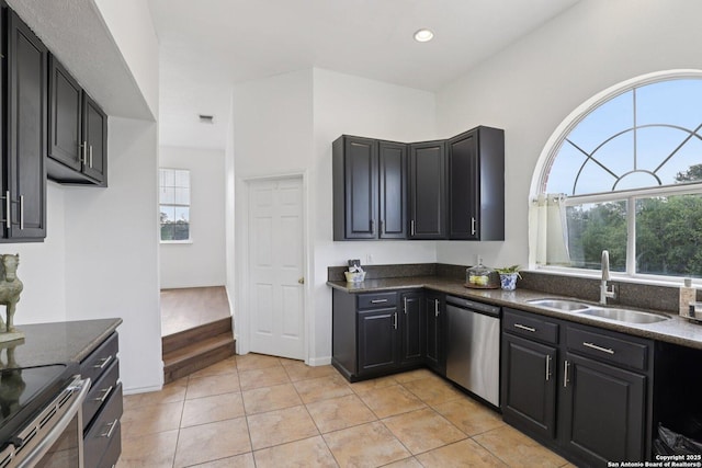 23613 Grayling Ln, San Antonio, TX 78259 - kitchen featuring stainless steel appliances, plenty of natural light, light tile patterned floors, dark cabinetry, and recessed lighting