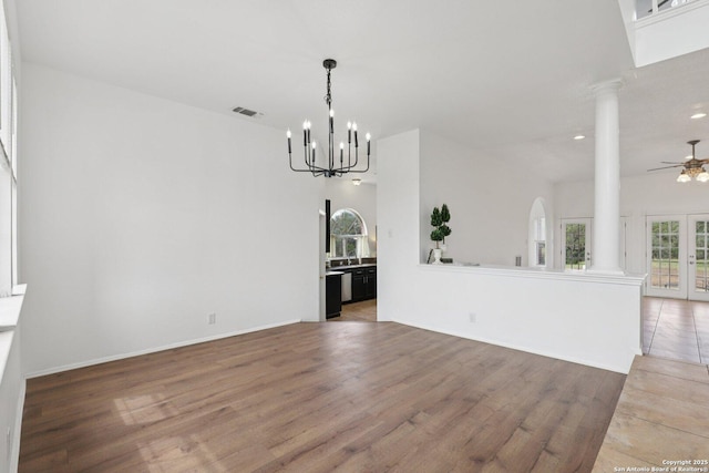 23613 Grayling Ln, San Antonio, TX 78259 - unfurnished living room with ornate columns, light wood finished floors, a chandelier, a ceiling fan, and recessed lighting