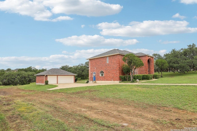 23613 Grayling Ln, San Antonio, TX 78259 - view of side of property featuring brick siding, an outbuilding, a detached garage, driveway, and a lawn