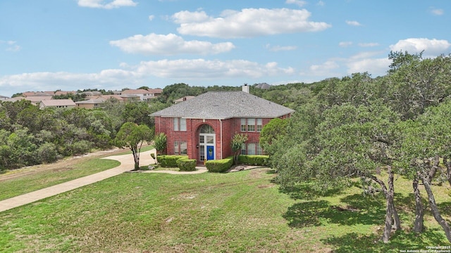 23613 Grayling Ln, San Antonio, TX 78259 - view of front of property with a front lawn, brick siding, and a chimney
