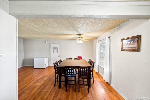 702 John Adams, San Antonio, TX 78228 - dining area featuring wood finished floors, a ceiling fan, a textured wall, and a textured ceiling