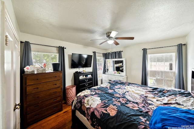 702 John Adams, San Antonio, TX 78228 - bedroom with dark wood-style flooring, a textured ceiling, and ceiling fan