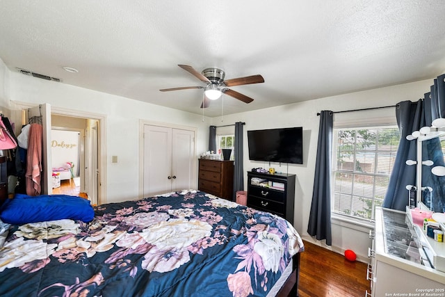 702 John Adams, San Antonio, TX 78228 - bedroom with dark wood finished floors, ceiling fan, a textured ceiling, and a closet