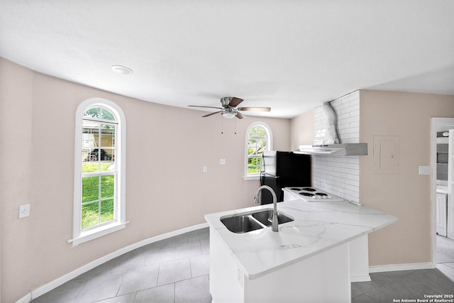 702 John Adams, San Antonio, TX 78228 - kitchen with freestanding refrigerator, light tile patterned floors, a peninsula, light countertops, and white electric stovetop