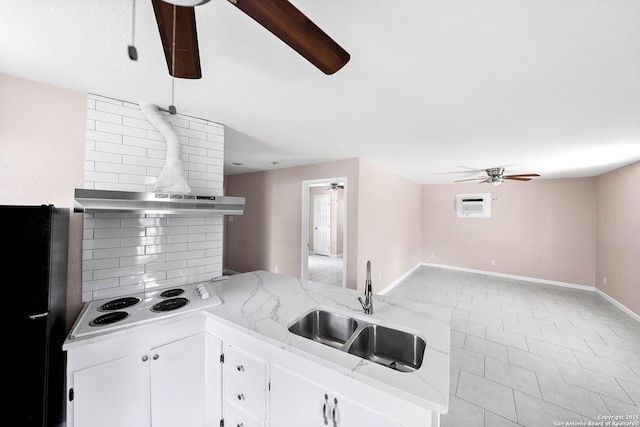 702 John Adams, San Antonio, TX 78228 - kitchen with white electric stovetop, a ceiling fan, freestanding refrigerator, light stone counters, and white cabinets
