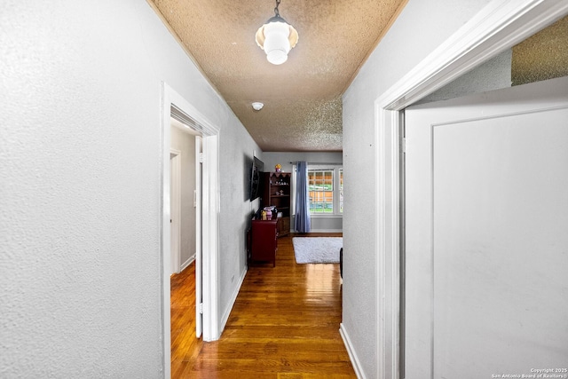 702 John Adams, San Antonio, TX 78228 - hallway with a textured ceiling, wood finished floors, and a textured wall