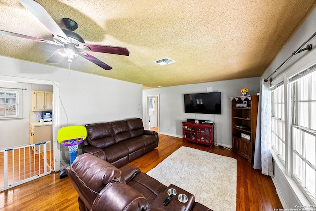 702 John Adams, San Antonio, TX 78228 - living room featuring a textured ceiling, plenty of natural light, wood finished floors, and ceiling fan