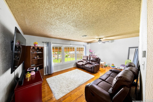 702 John Adams, San Antonio, TX 78228 - living area featuring ceiling fan, wood finished floors, and a textured ceiling