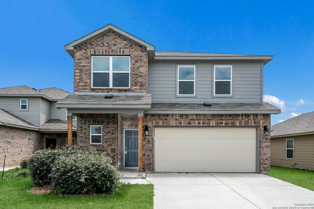 12810 Olson Pt, San Antonio, TX 78252 - view of front of house featuring brick siding, concrete driveway, and an attached garage