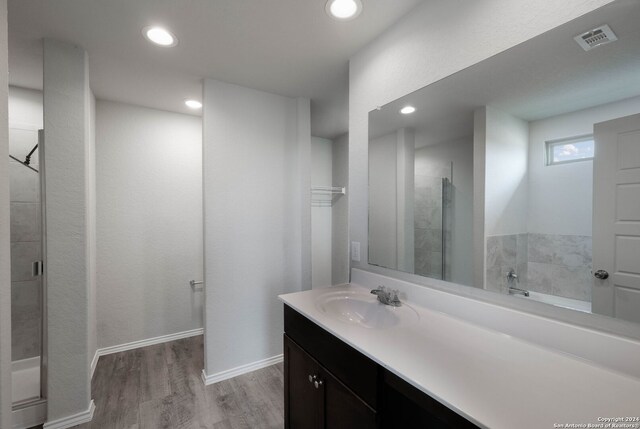 12810 Olson Pt, San Antonio, TX 78252 - full bathroom with vanity, wood finished floors, a stall shower, and recessed lighting