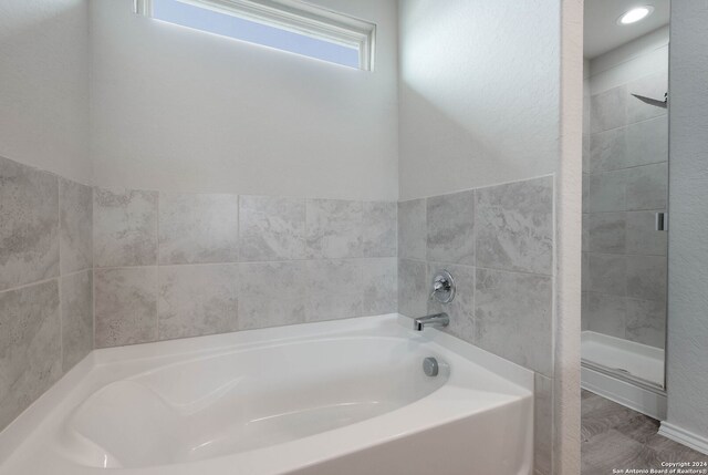 12810 Olson Pt, San Antonio, TX 78252 - full bath with a garden tub and a stall shower
