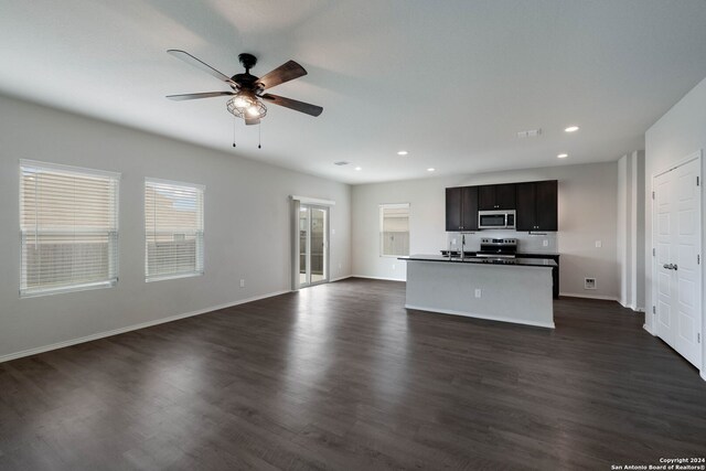 12810 Olson Pt, San Antonio, TX 78252 - unfurnished living room with ceiling fan, dark wood-type flooring, and recessed lighting
