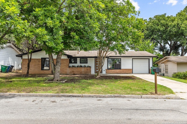 4426 Newcome, San Antonio, TX 78229 - view of front of house with brick siding, a garage, concrete driveway, and a front lawn