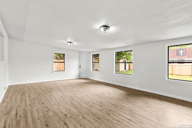 4426 Newcome, San Antonio, TX 78229 - unfurnished room with healthy amount of natural light and wood finished floors