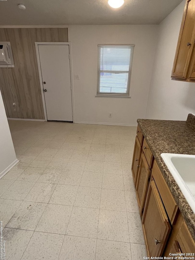 627 Baltzell, San Antonio, TX 78221 - kitchen featuring brown cabinetry and dark stone countertops