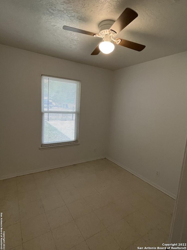 627 Baltzell, San Antonio, TX 78221 - spare room featuring a textured ceiling, a ceiling fan, and light floors