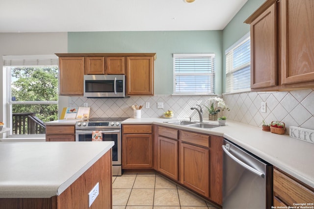 4922 Augusta, San Antonio, TX 78247 - kitchen with appliances with stainless steel finishes, light countertops, decorative backsplash, light tile patterned floors, and brown cabinets