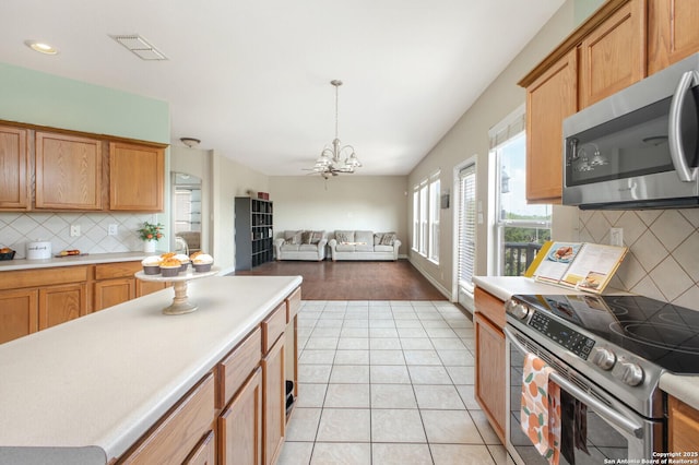 4922 Augusta, San Antonio, TX 78247 - kitchen featuring stainless steel appliances, tasteful backsplash, light countertops, and a chandelier
