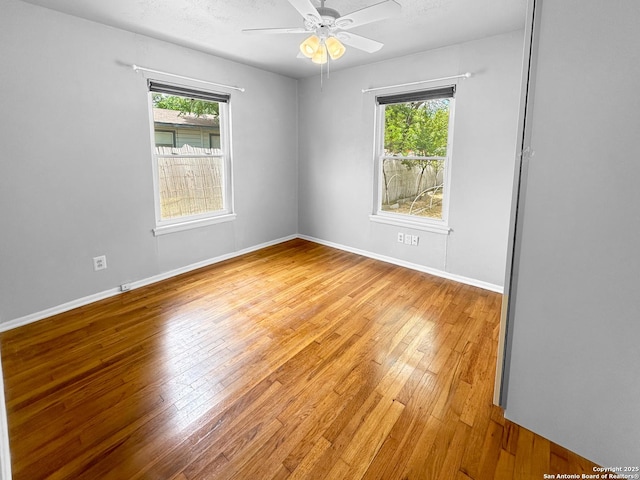 737 N Central, New Braunfels, TX 78130 - empty room featuring plenty of natural light, light wood-style floors, and a ceiling fan
