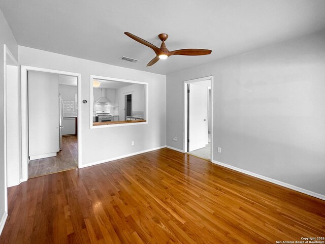 737 N Central, New Braunfels, TX 78130 - unfurnished living room with ceiling fan and wood finished floors