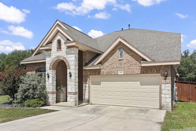 8503 Kallison Arbor, San Antonio, TX 78254 - view of front facade with roof with shingles, stone siding, brick siding, driveway, and a garage