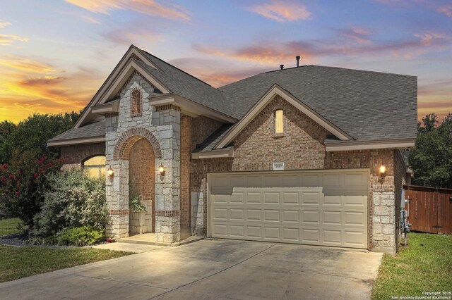 8503 Kallison Arbor, San Antonio, TX 78254 - view of front facade featuring stone siding, roof with shingles, driveway, and a garage