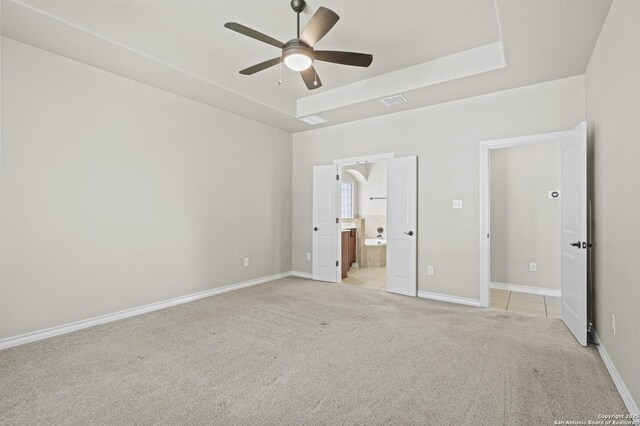 8503 Kallison Arbor, San Antonio, TX 78254 - unfurnished bedroom with light colored carpet, a raised ceiling, connected bathroom, and ceiling fan