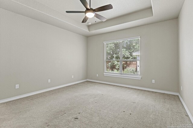 8503 Kallison Arbor, San Antonio, TX 78254 - carpeted empty room featuring a ceiling fan and a tray ceiling