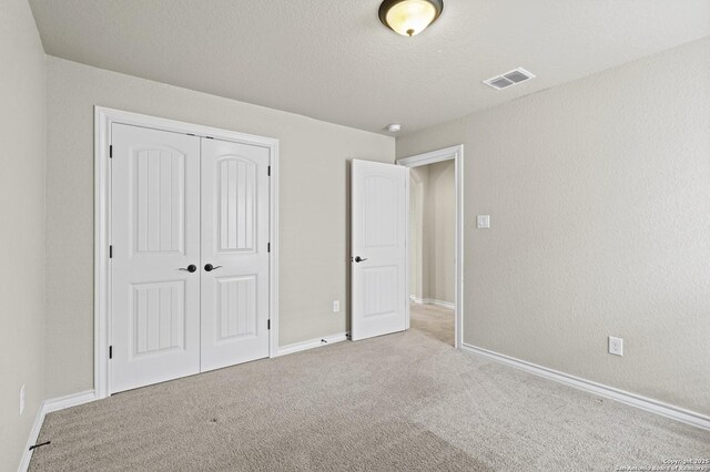 8503 Kallison Arbor, San Antonio, TX 78254 - unfurnished bedroom featuring carpet, a closet, and a textured ceiling