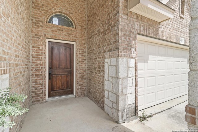 8503 Kallison Arbor, San Antonio, TX 78254 - doorway to property featuring brick siding and a garage