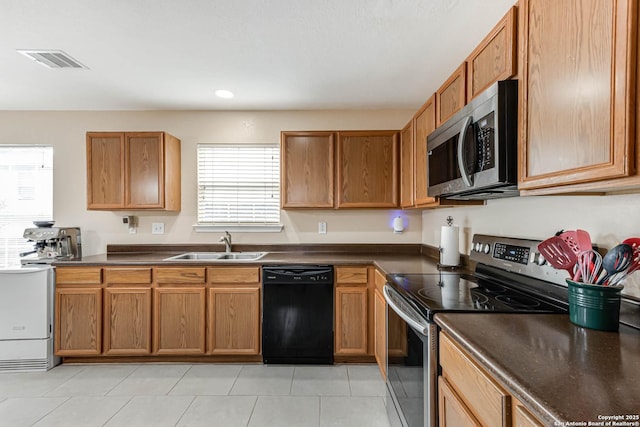 16102 Barrell Run, San Antonio, TX 78247 - kitchen with appliances with stainless steel finishes, dark countertops, recessed lighting, brown cabinetry, and washer / clothes dryer