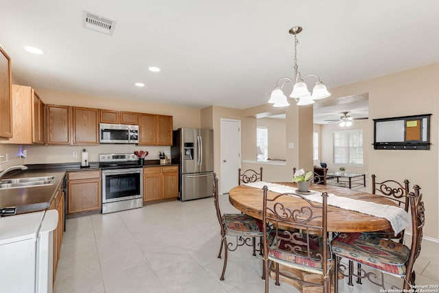 16102 Barrell Run, San Antonio, TX 78247 - kitchen with appliances with stainless steel finishes, dark countertops, hanging light fixtures, recessed lighting, and a chandelier