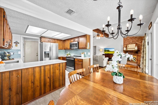 3527 Oakhorne St, San Antonio, TX 78247 - dining room with a chandelier, a textured ceiling, and a ceiling fan