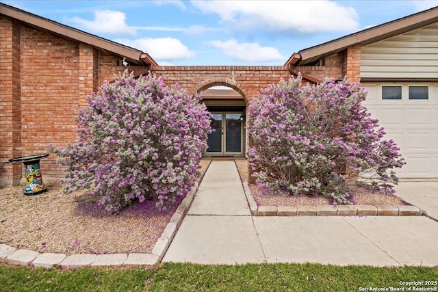 3527 Oakhorne St, San Antonio, TX 78247 - view of exterior entry featuring brick siding and an attached garage