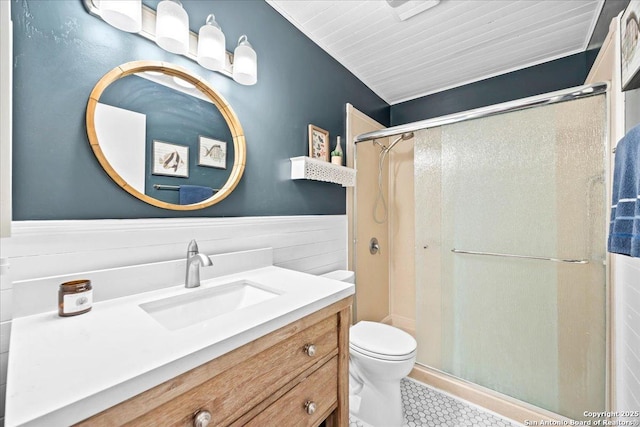 3527 Oakhorne St, San Antonio, TX 78247 - bathroom featuring a stall shower, vanity, wainscoting, and tile patterned flooring