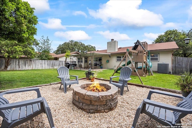 3527 Oakhorne St, San Antonio, TX 78247 - fenced backyard featuring an outdoor fire pit, a playground, and a patio