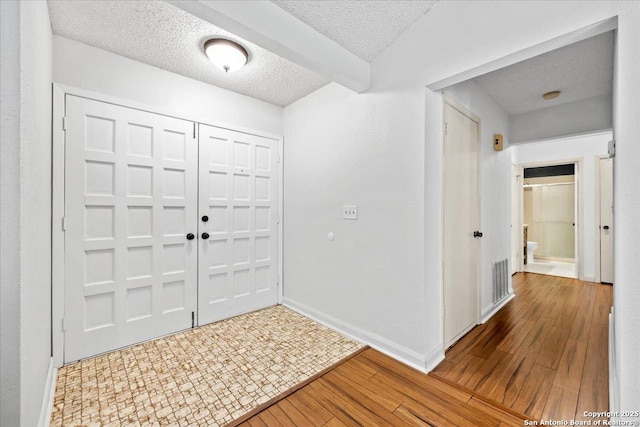 3527 Oakhorne St, San Antonio, TX 78247 - entryway featuring wood finished floors and a textured ceiling