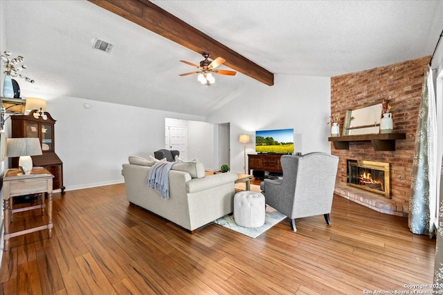 3527 Oakhorne St, San Antonio, TX 78247 - living room featuring hardwood / wood-style floors, a fireplace, ceiling fan, and a textured ceiling